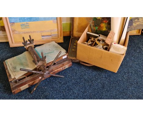 A collection of Elizabeth Coombe art tools to include paints, travel box, and press.