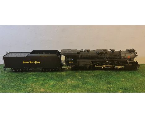 An Aster Hobby live steam Nickel Plate Road 779 Berkshire gauge 1 model train and tender and assembly and operating booklets.