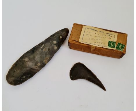 A flint axe head approx 23cm 5 1/2 cm with flint tool approx 10 cm 5 1/2 cm.