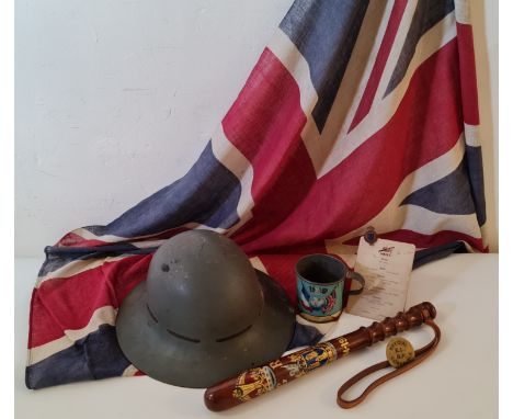 A WW1 British helmet Union Jack flag 1919 peace tin cup and a 1914-1918 truncheon.