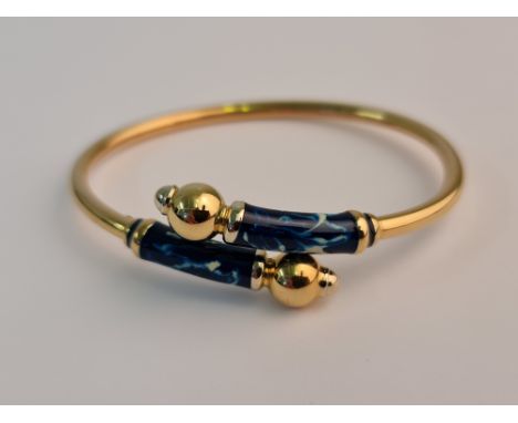 A blue and white enamel cross over design bangle, stamped 750 approx.weight 13gms.