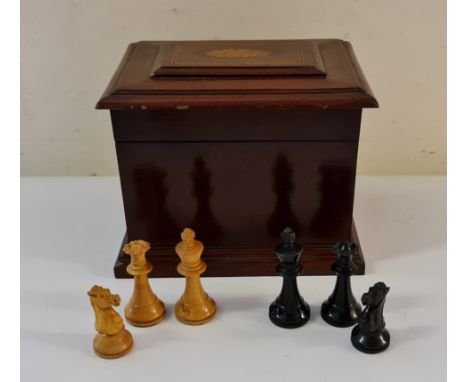 A ebony and boxwood chess board pieces in mahogany box.