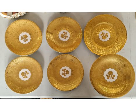 Four Royal Worcester gilded plates with rose to centre one larger plate and one tazza.