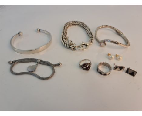 A collection of jewellery to include, a hallmarked silver torque bangle, a foxtail bracelet linked together with a fan charm,