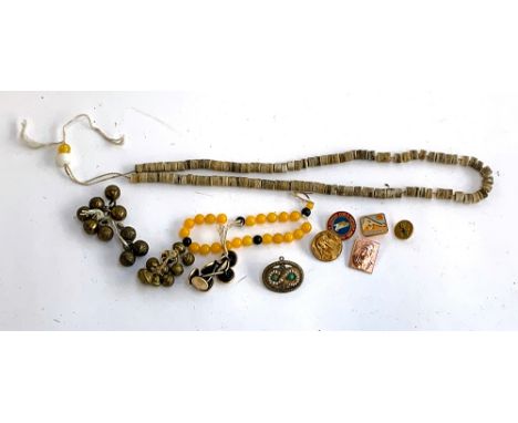 A mixed lot to include bone rosary beads, various other beads, modern Mongolian enamel badges and buttons, turquoise and seed