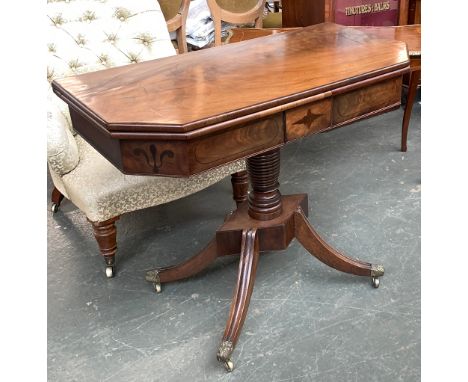 A Regency card table, foldover top with canted corners, apron with inlaid decoration, on a ring turned column, lozenge base a