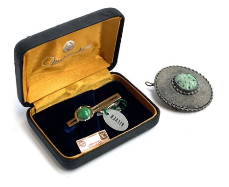 A sterling silver pendant/brooch set with a central pierced jade lozenge, 4.5cmD; together with a silver Shippo tie clip set 