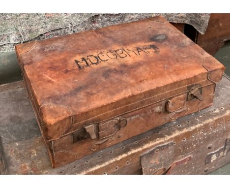 A leather suitcase, marked MD Cobham (handle missing), 62x42x20cm; together with a canvas and leather travel trunk, 91x91cmW 