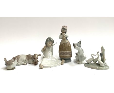 Five Lladro figurines to include seated angel, girl with apron, 21.5cmH, cat, cow and songbird, together with a Nao figure of