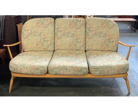 An Ercol three seater beech framed stick back sofa, 175cmW 