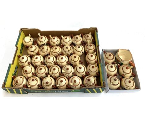 A quantity of ceramic novelty sugar bowls in the form of teapots from various English towns 