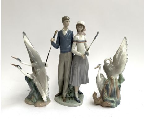 A Lladro figurine of golfers, 34cmH, together with 2 Nao figurines of cranes 