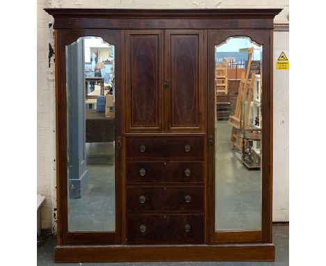 An Edwardian gents compactum wardrobe, central section with cupboard doors over four drawers, flanked either side by hanging 