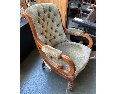 An early 20th century buttonback open armchair, on turned legs and ceramic casters 