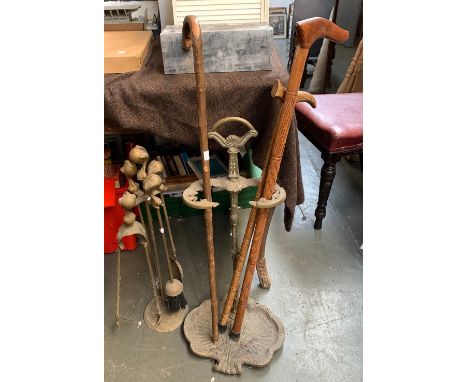 A brass stick stand with scalloped base, 69cmH, together with a brass set of fire tools, 64cmH and 3 walking sticks 