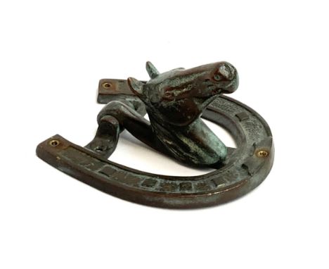 A brass door knocker in the form of a horse shoe and horse's head, 11.5cmL 