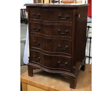 A serpentine bedside cabinet of four drawers, on bracket feet, 50x41x71cmH; together with a giltwood style table lamp, 67cmH 