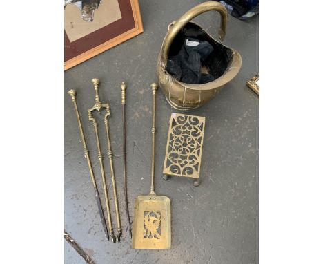 A brass helmet coal scuttle, pierced brass trivet and 4 fire tools 