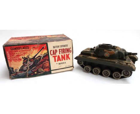 A battery operated cap firing tank by Marx, boxed, missing piece to top of tank, box damaged 
