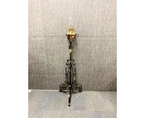 A Victorian telescopic wrought iron and brass oil lamp with a spare chimney, H. 151cm (with chimney).