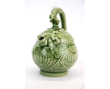 A Chinese incised and celadon glazed porcelain mystery teapot, H. 18.5cm.