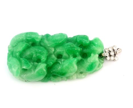 A large carved jade pendant on a white metal (tested 18ct gold) bail set with brilliant and baguette cut diamonds, L. 8.5cm, 