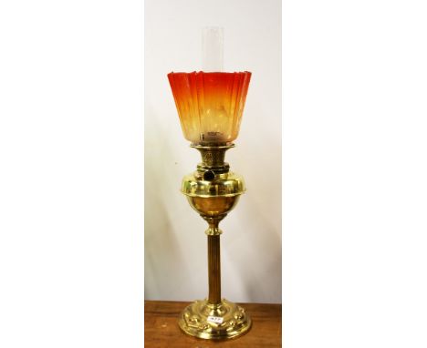 An unusual Art Nouveau brass oil lamp with original etched vivid orange shade, overall H. 74cm.