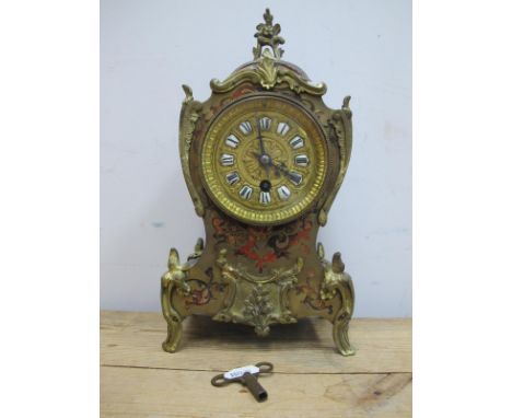 A Late XIX Century Boulle Cased Mantle Clock, of rococo form, with flower surmount, the circular dial with white enamel panel