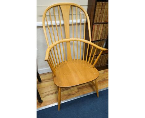 An Ercol light elm and beech comb back Windsor armchair