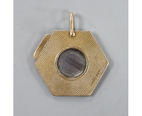A 1960's engine turned 9ct gold hexagonal cigar cutter, 34mm.