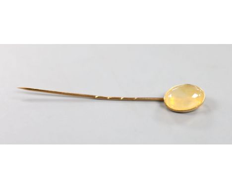 An early 20th century yellow metal and opal? set stick pin, 7cm, gross weight 2.4 grams.