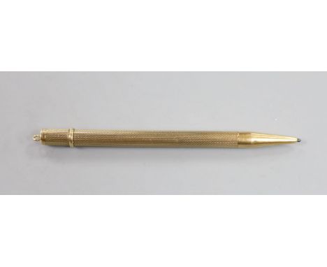 An engine turned 9ct gold cased pencil, 86mm, gross weight 10.5 grams.