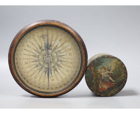 A 19th century circular papier mache box and cover decorated with cherubs and a compass from a library globe, diameter 14cm