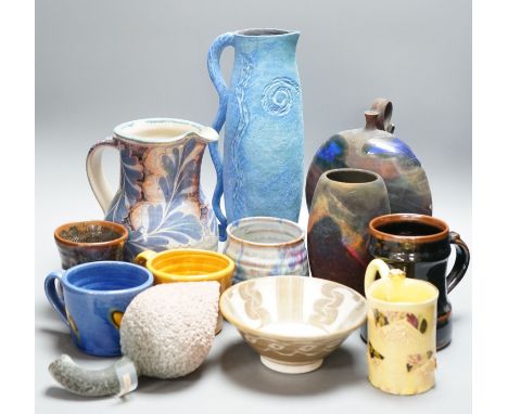 A group of studio pottery jugs, mugs, and other vessels to include –a tall Nancy Angus jug, an Owen Thorpe jug, a Dave Cohen 
