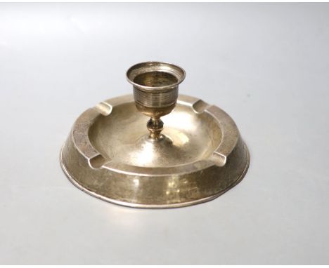 An Edwardian silver mounted combination ashtray/candlestick, Birmingham, 1908, diameter 14.4cm, weighted.