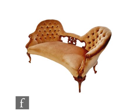 A Victorian chaise carved walnut double spoon back chaise langue, pierced splat on cabriole legs, upholstered in light plush,