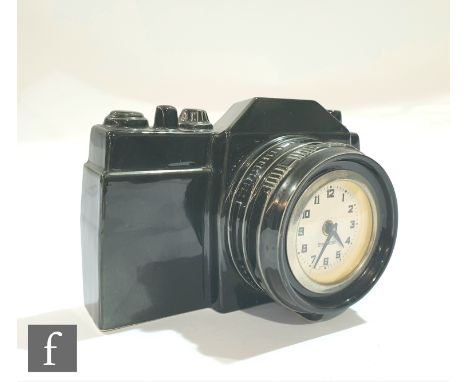 A mid 20th Century Mercedes 'Flying Saucer' clock, modelled as a camera in black finish, 12cm x 16cm. 