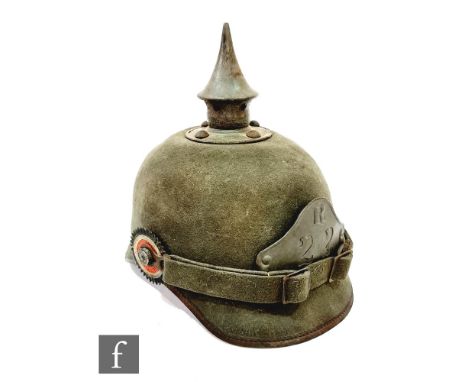 A World War One German Ersatz pickelhaube helmet in green cloth for R 22 division, original lining and strap, one rosette mis