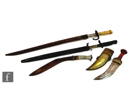 A Remington 1917 pattern bayonet and scabbard, a French bayonet and scabbard, an Indian dagger and a kukri. (4) 