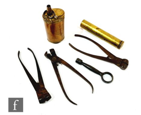 A small 19th Century copper and brass powder flask, a brass oil container, a lock key and three pistol ball moulds. (6) 