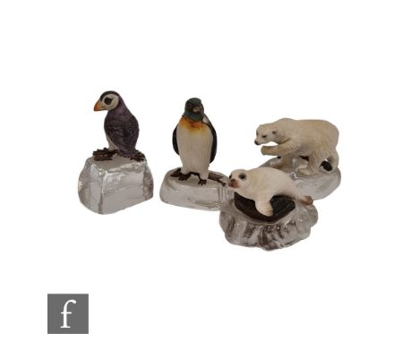 Four miniature Albany China models of animals and birds with metal mounts and affixed to clear glass rocks, comprising a whit