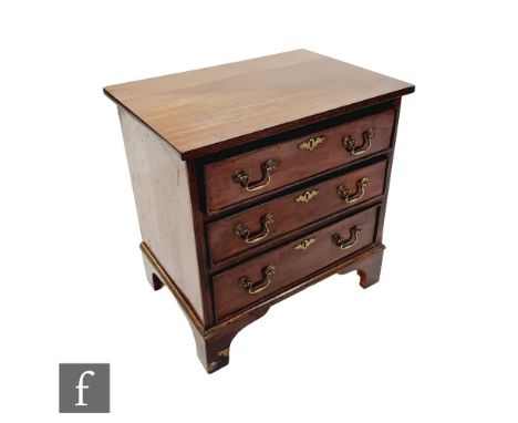 A small George III style mahogany chest of three long drawers, brass swing drop handles, on bracket feet, height 54cm x depth