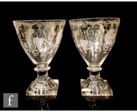 A late 18th Century pair of rummers, each with lemon squeezer foot, plain stem with bladed knop and funnel bowl engraved with