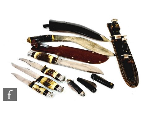 A William Rogers Bowie knife with tooled leather scabbard, three similar Bowie knives, an ALCF Spanish knife with smaller kni