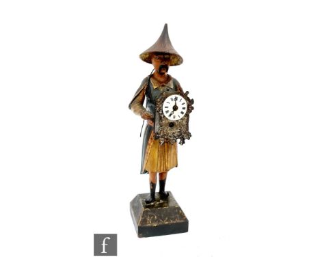 An early 20th clock automaton of a Chinese man wearing a hat and traditional clothes and holding a clock with spring driven b