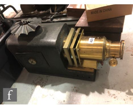A Victorian brass magic lantern, converted to electricity, length 61cm, and two wooden cases of standard slides of India etc.