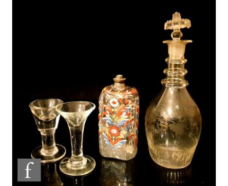 An early 19th Century pressed glass spirit decanter of Prussian form with basal moulding beneath an engraved fruiting vine, t