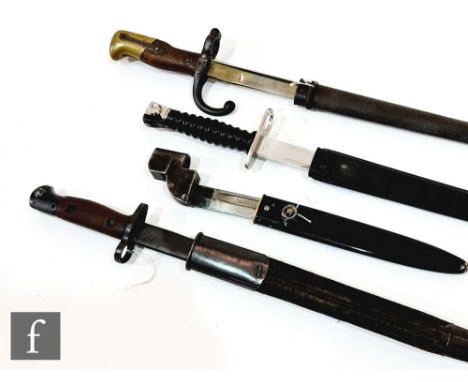 A 19th Century French engraved socket bayonet with scabbard, a Mark II bayonet and scabbard and two other similar bayonets. (