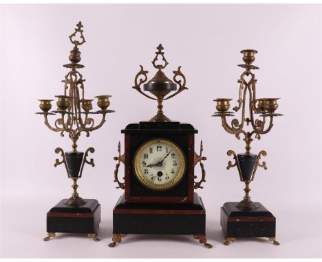 A three-part black/red marble mantel clock set, executed in neo-styles, France, 2nd half of the 19th century. Consisting of: 