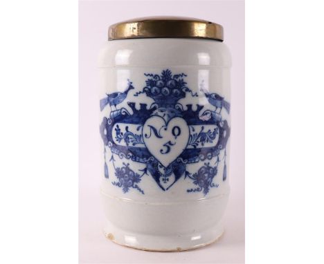 A Delft blue pottery albarello apothecary jar with brass lid, Holland 18th century. Decor of cartouche crowned with peacocks 